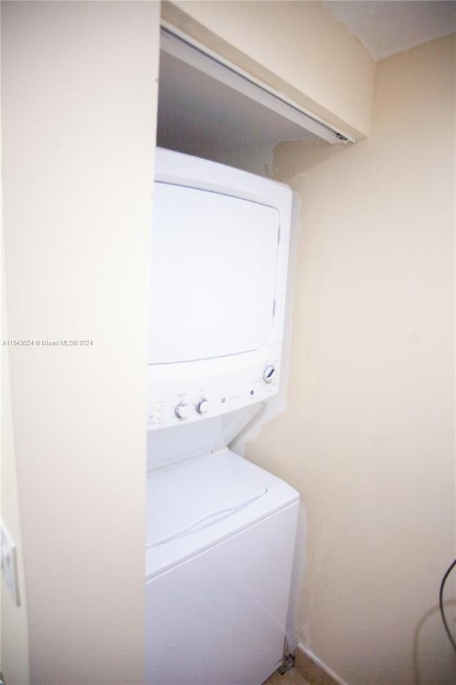 laundry area featuring stacked washing maching and dryer