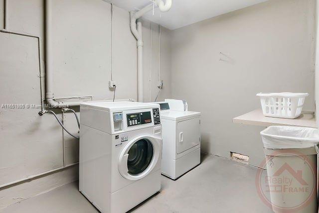 washroom with washing machine and dryer