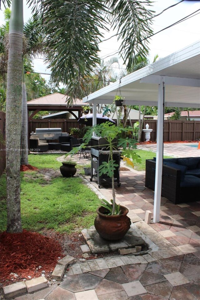 view of yard with outdoor lounge area, a patio area, and a gazebo