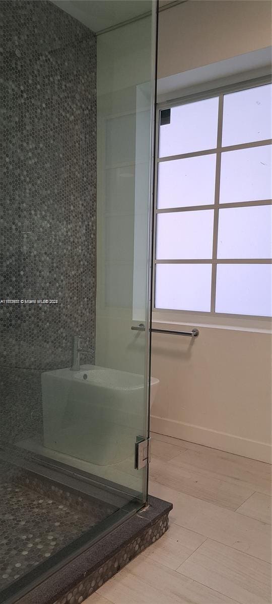 846 Michigan Ave Unit 101, Miami Beach, FL 33139 - full bath featuring a shower stall and wood finished floors