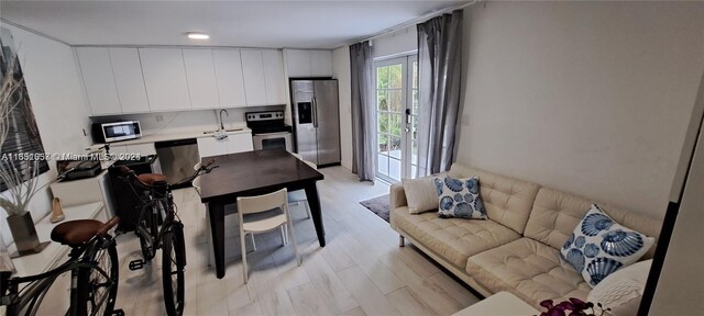 846 Michigan Ave Unit 101, Miami Beach, FL 33139 - living area with light wood-type flooring