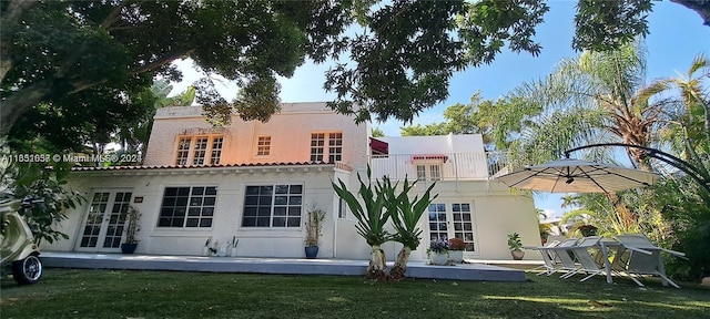 846 Michigan Ave Unit 101, Miami Beach, FL 33139 - back of house with french doors, a lawn, and a balcony