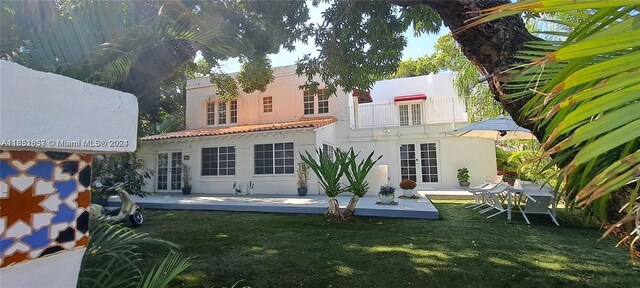 846 Michigan Ave Unit 101, Miami Beach, FL 33139 - back of house featuring a yard, stucco siding, french doors, and a balcony