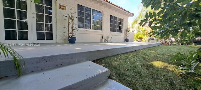 846 Michigan Ave Unit 101, Miami Beach, FL 33139 - doorway to property with stucco siding, a tile roof, and a yard