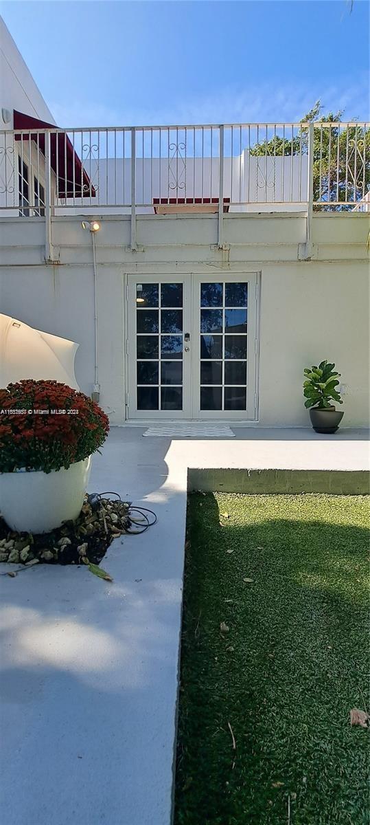 846 Michigan Ave Unit 101, Miami Beach, FL 33139 - property entrance with stucco siding and french doors