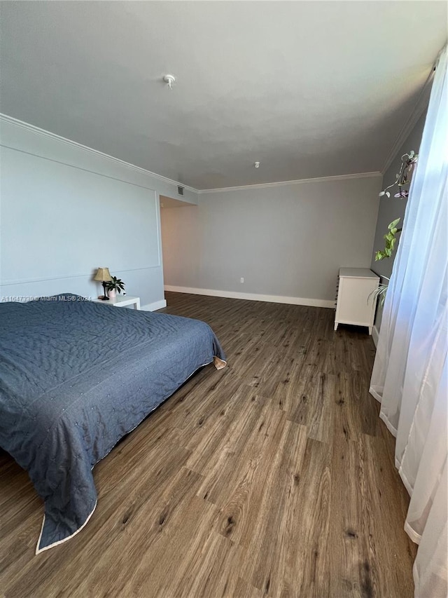 bedroom featuring hardwood / wood-style floors and ornamental molding