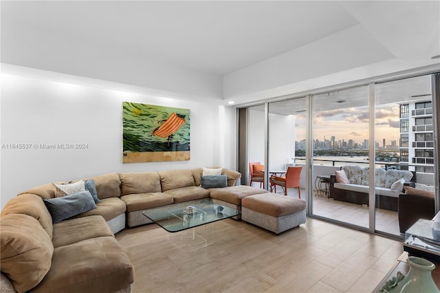 living room featuring light wood-type flooring and expansive windows