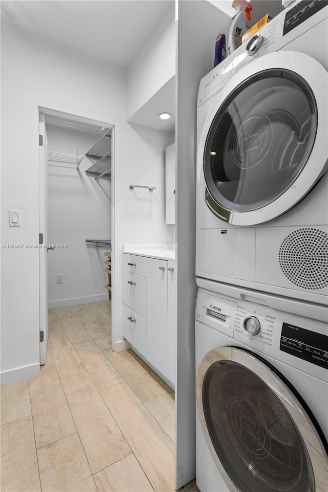 laundry area featuring stacked washing maching and dryer