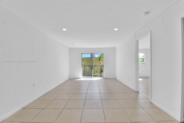 tiled empty room featuring plenty of natural light