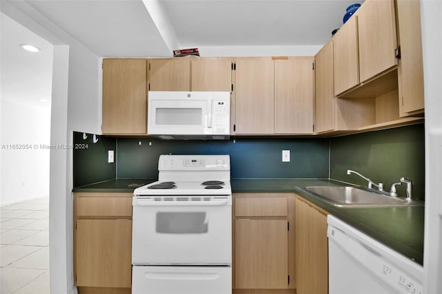 kitchen featuring light tile patterned floors, white appliances, light brown cabinetry, and sink