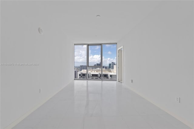 tiled spare room with expansive windows