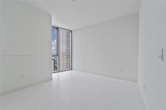 unfurnished room featuring floor to ceiling windows