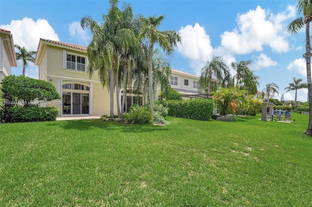 rear view of house with a yard