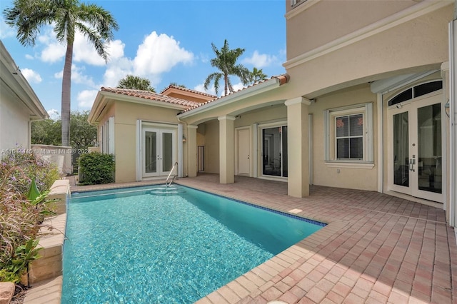 view of pool with a patio and french doors