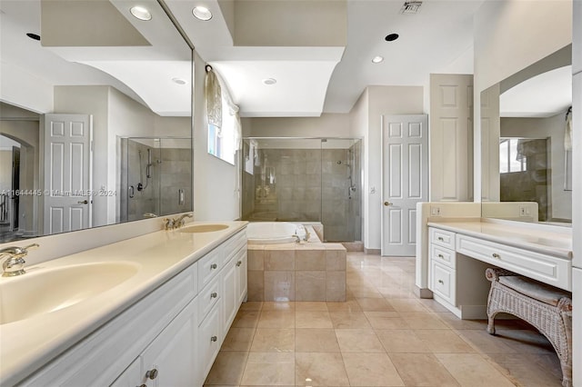 bathroom featuring tile patterned flooring, shower with separate bathtub, and vanity