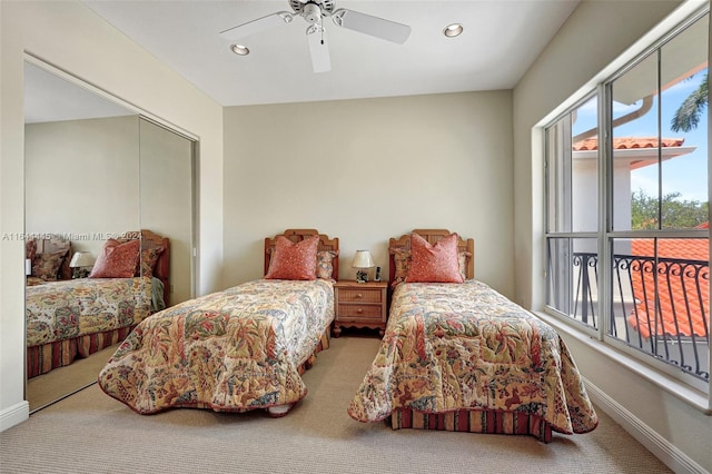 bedroom with a closet, ceiling fan, and carpet flooring