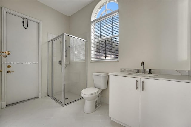 bathroom with tile patterned flooring, walk in shower, toilet, and vanity