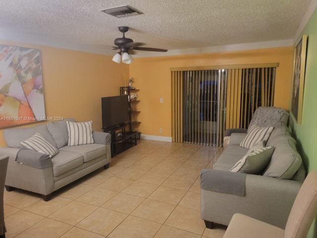 tiled living room featuring ceiling fan and a textured ceiling