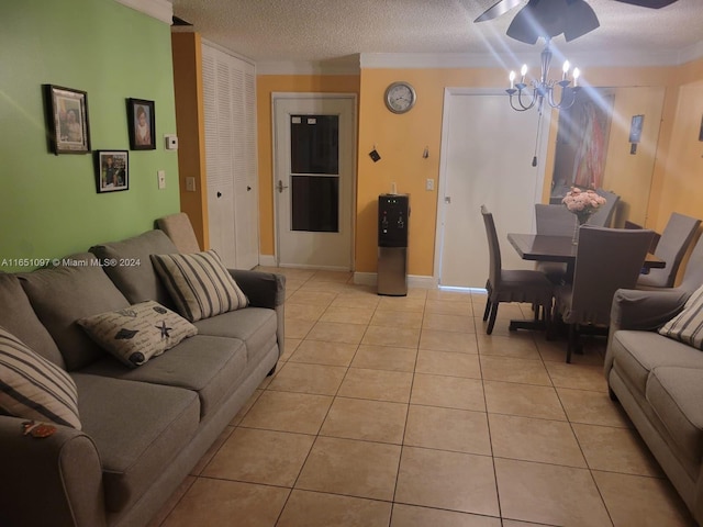 living room featuring a textured ceiling, ceiling fan with notable chandelier, and light tile patterned flooring