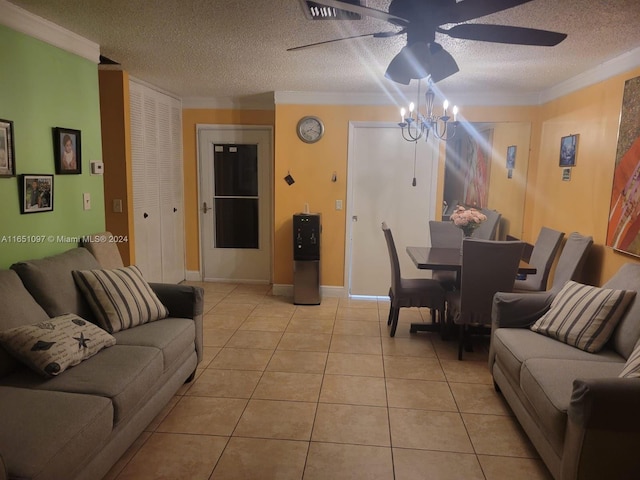 living room featuring ceiling fan with notable chandelier, light tile patterned floors, ornamental molding, and a textured ceiling