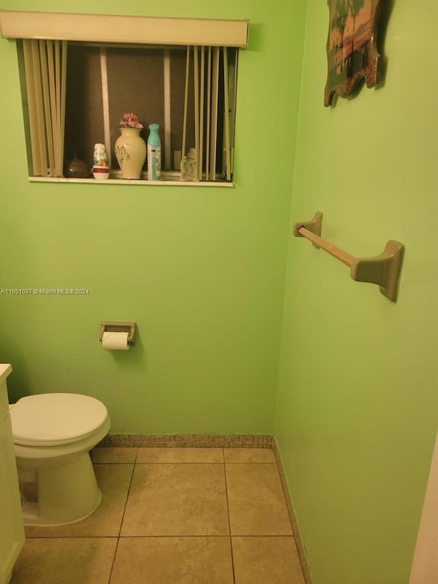 bathroom featuring vanity, toilet, and tile patterned flooring