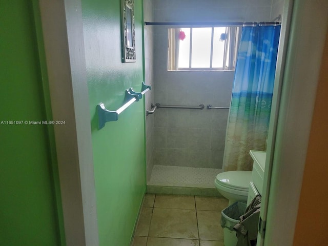 bathroom featuring vanity, toilet, walk in shower, and tile patterned floors