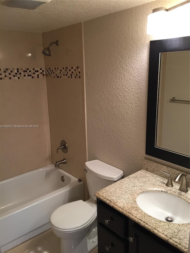 bathroom with a textured ceiling, a textured wall, shower / bathtub combination, toilet, and vanity