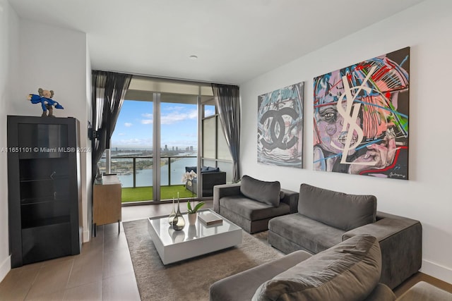 living room with a water view and a wall of windows