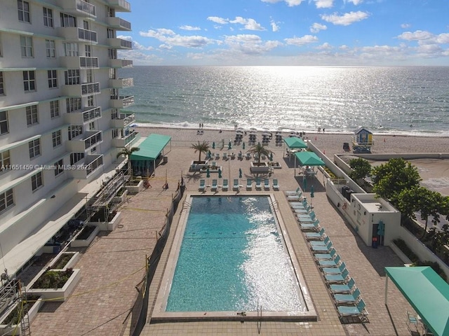 view of pool with a beach view and a water view