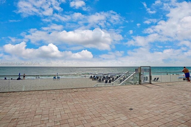 view of property's community with a beach view and a water view