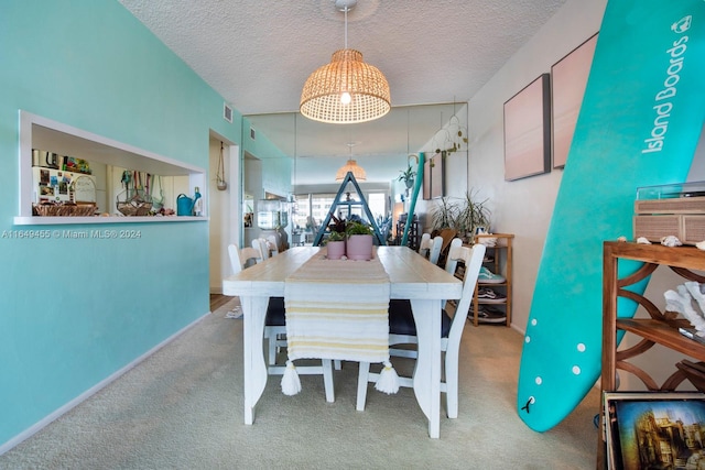 dining area with carpet floors and a textured ceiling