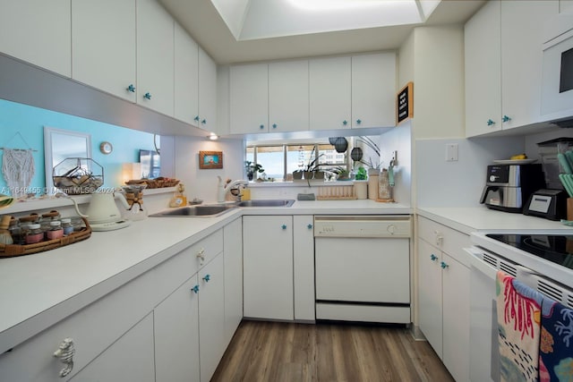 kitchen with sink, hardwood / wood-style floors, white appliances, and white cabinets