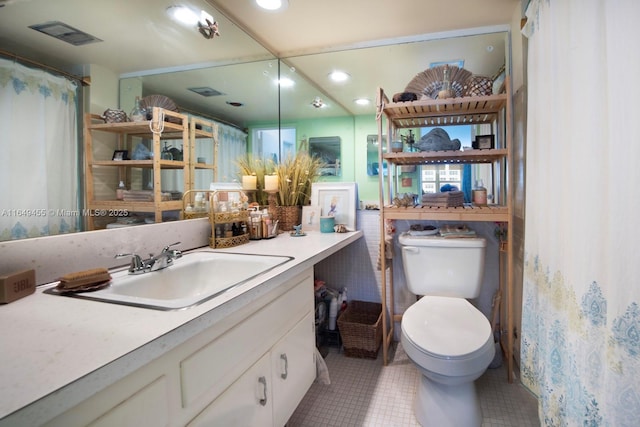 bathroom featuring tile patterned floors, toilet, and vanity