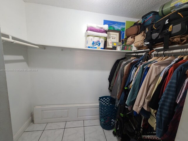 spacious closet featuring light tile patterned flooring