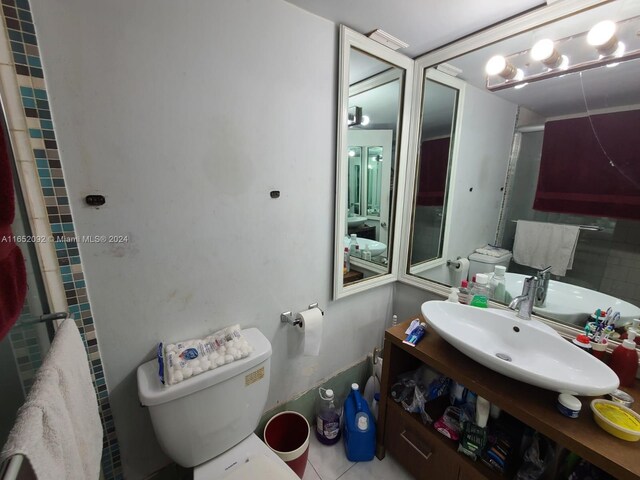 bathroom with tile patterned flooring, toilet, and vanity