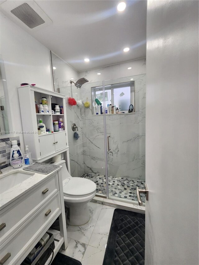 bathroom with vanity, toilet, and walk in shower