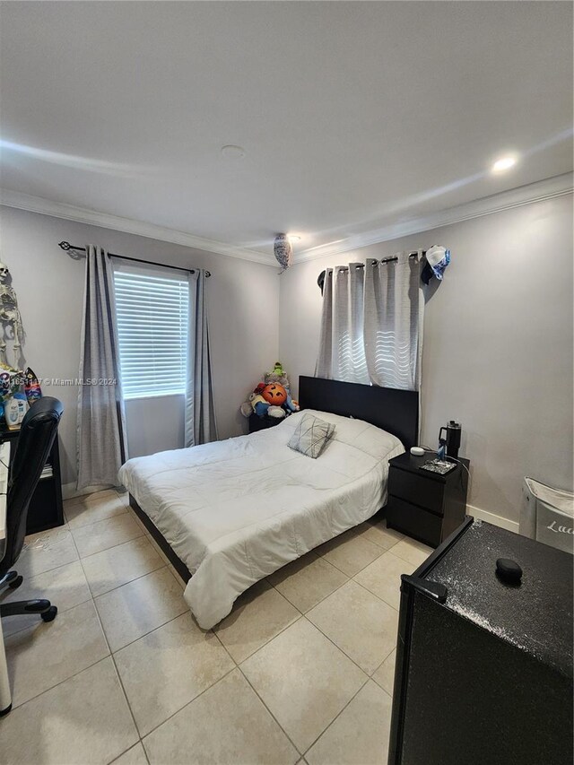 tiled bedroom featuring ornamental molding