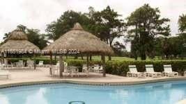 6100 NW 44th St Unit 405, Lauderhill, FL 33319 - community pool featuring a gazebo and a patio area