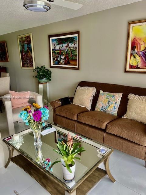 6100 NW 44th St Unit 405, Lauderhill, FL 33319 - living room with a textured ceiling and tile patterned flooring