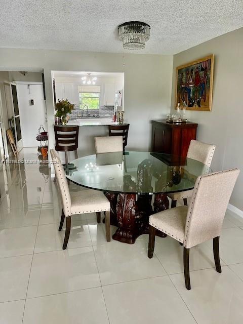 6100 NW 44th St Unit 405, Lauderhill, FL 33319 - dining room featuring a textured ceiling and light tile patterned floors