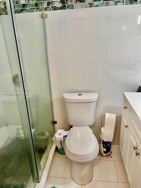 6100 NW 44th St Unit 405, Lauderhill, FL 33319 - bathroom with vanity, toilet, a stall shower, and tile patterned flooring