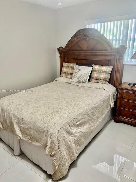 bedroom featuring light tile patterned floors