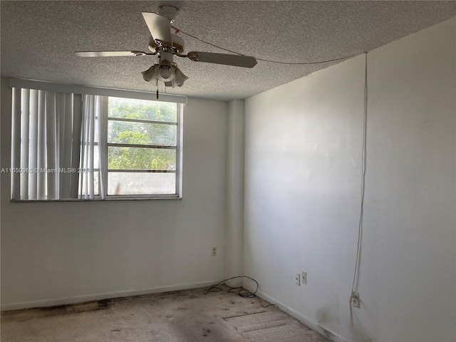 empty room with ceiling fan, a textured ceiling, and carpet