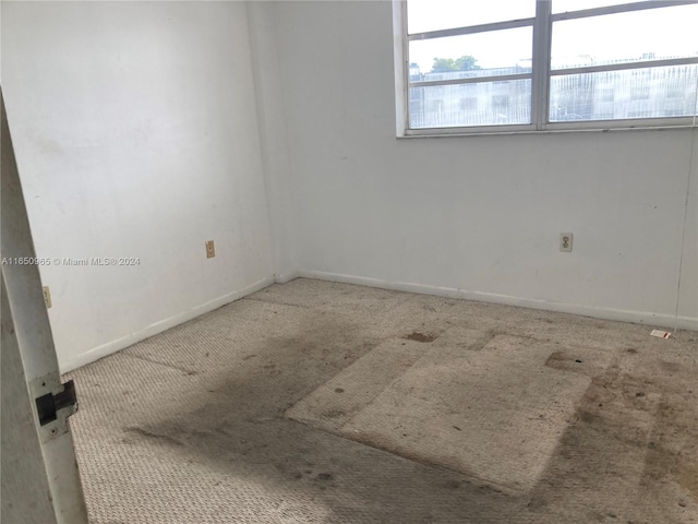 unfurnished room with carpet flooring