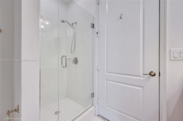 bathroom featuring tile patterned flooring and a shower with door