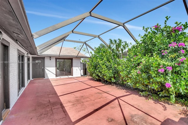 view of patio featuring glass enclosure