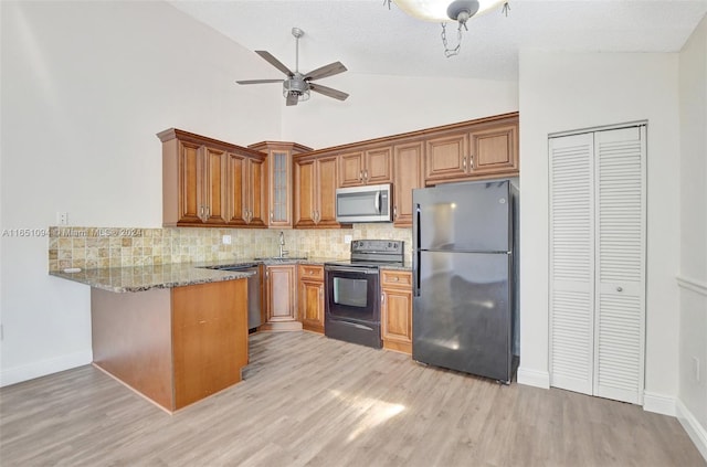 kitchen with black appliances, ceiling fan, light wood-type flooring, and stone countertops