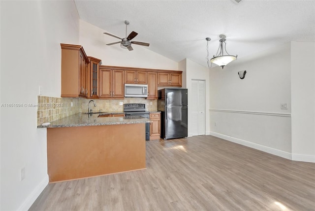 kitchen featuring black appliances, light stone counters, sink, kitchen peninsula, and ceiling fan