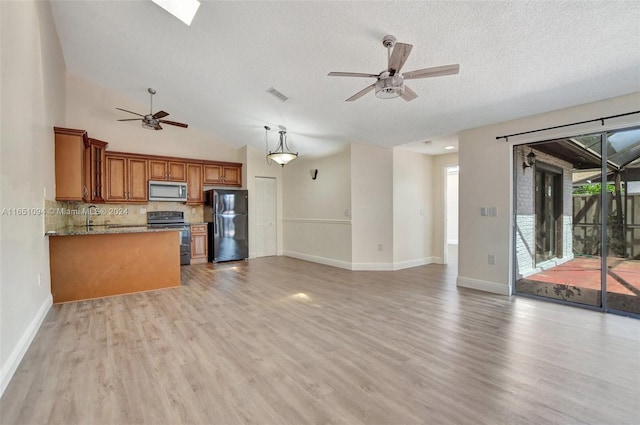 kitchen featuring black appliances, light hardwood / wood-style flooring, hanging light fixtures, ceiling fan, and stone counters