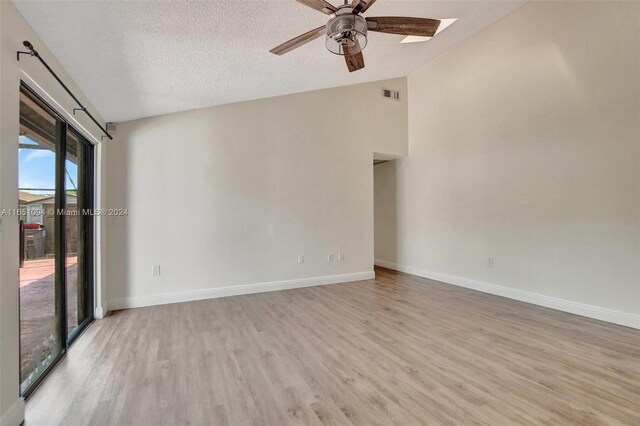 doorway with a textured ceiling and hardwood / wood-style floors